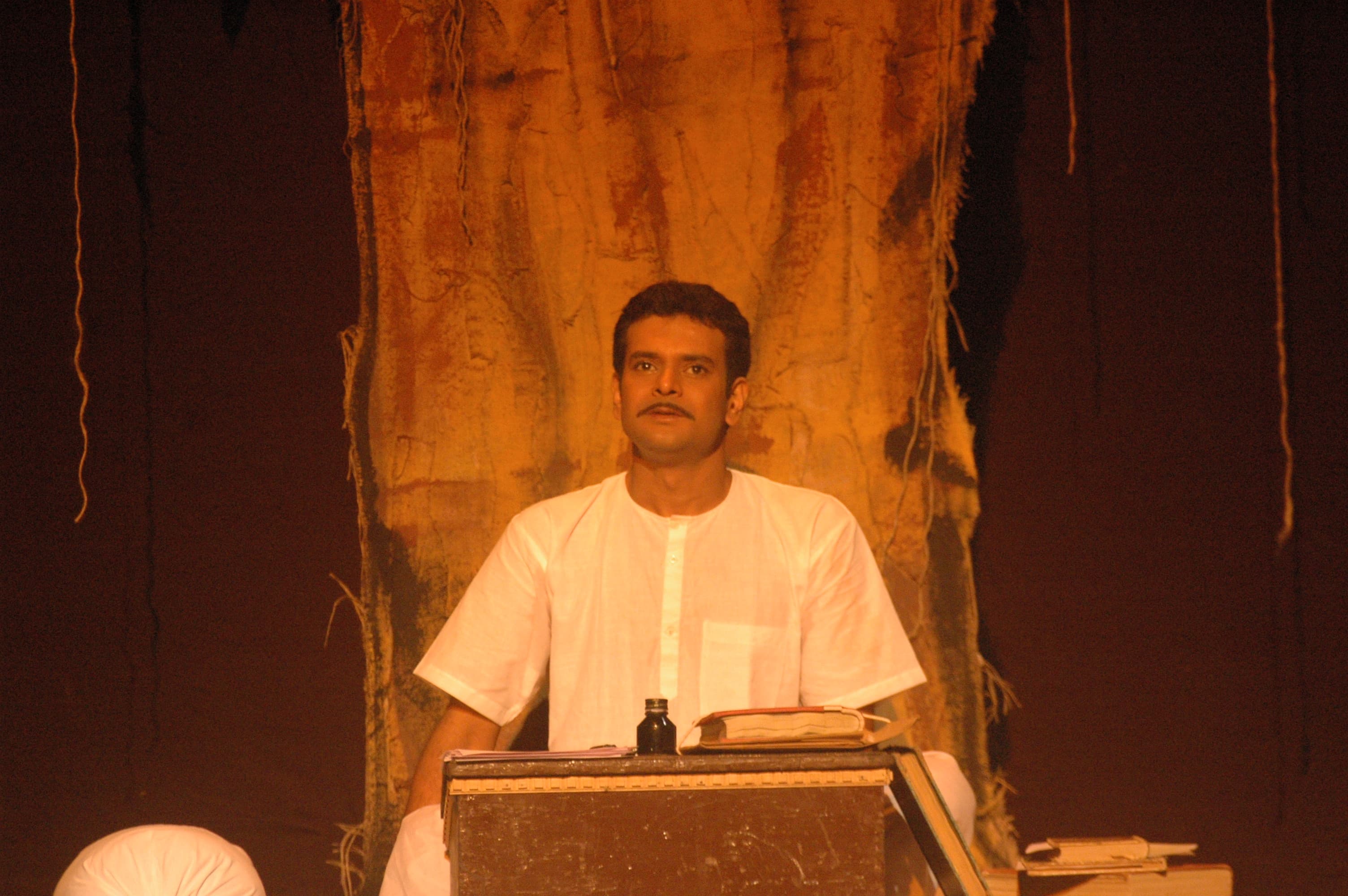 Dharmendra Gohil as Shrimad Rajchandra — the businessman-mystic at his desk